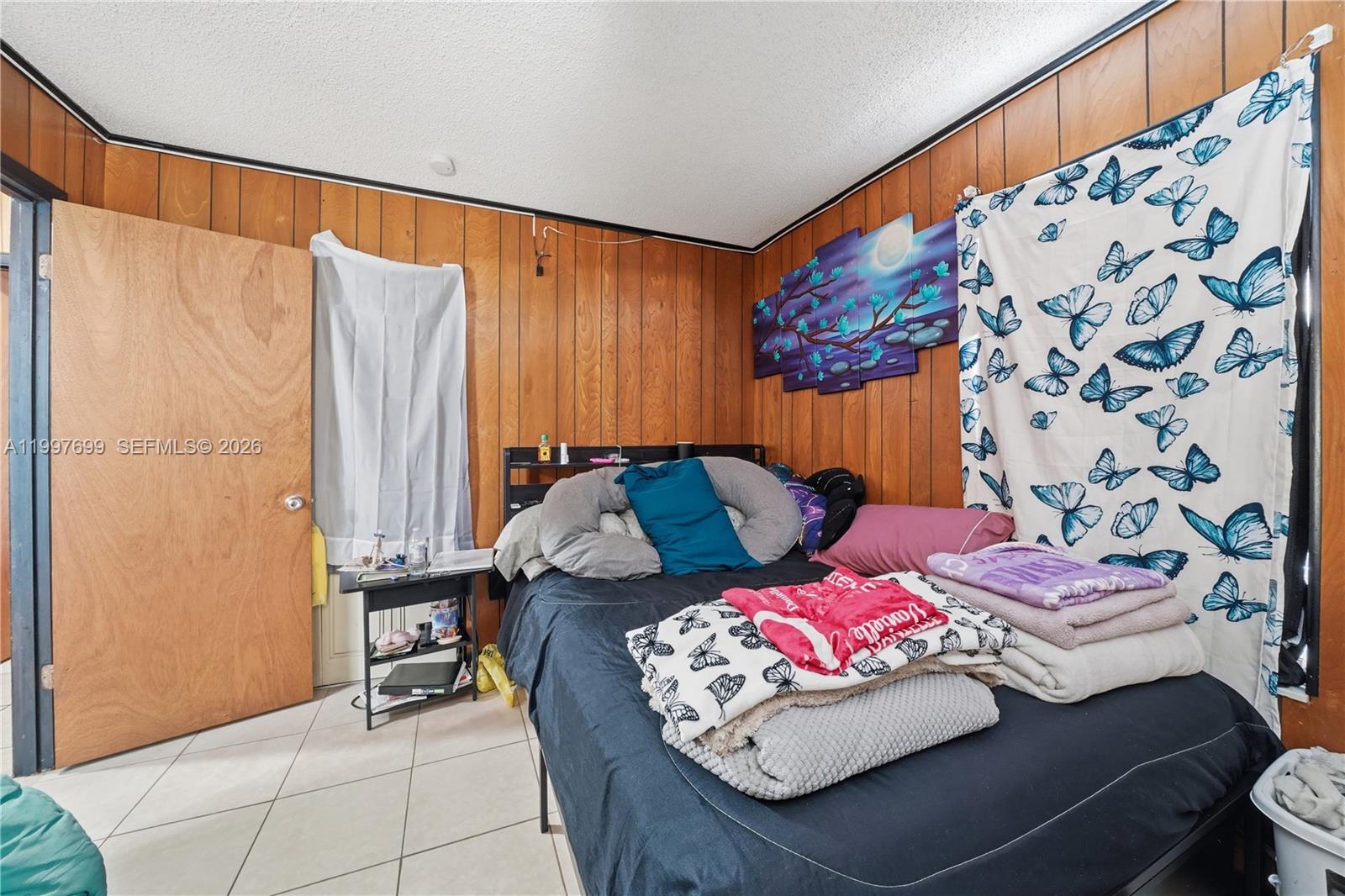 1910 South 34th Street Fort Pierce, FL 34947 - Photo 14 of 24 a bedroom with a bed and a table in it