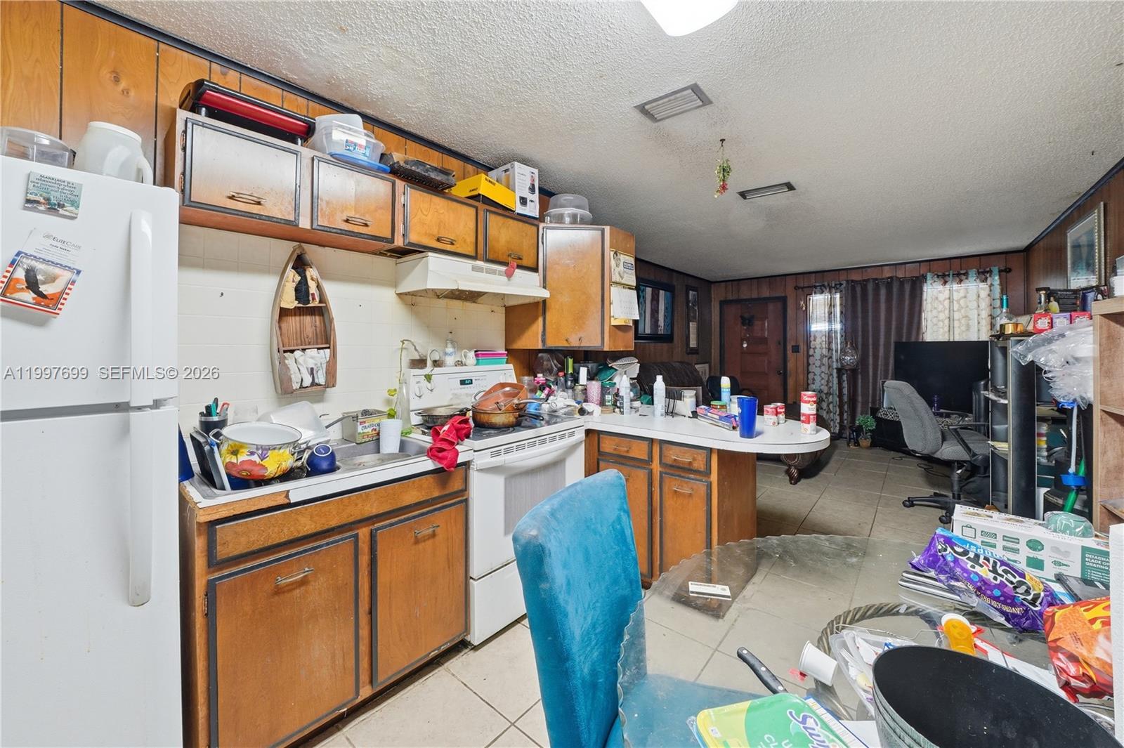 1910 South 34th Street Fort Pierce, FL 34947 - Photo 16 of 24 a kitchen filled with a white cabinets and wooden floor