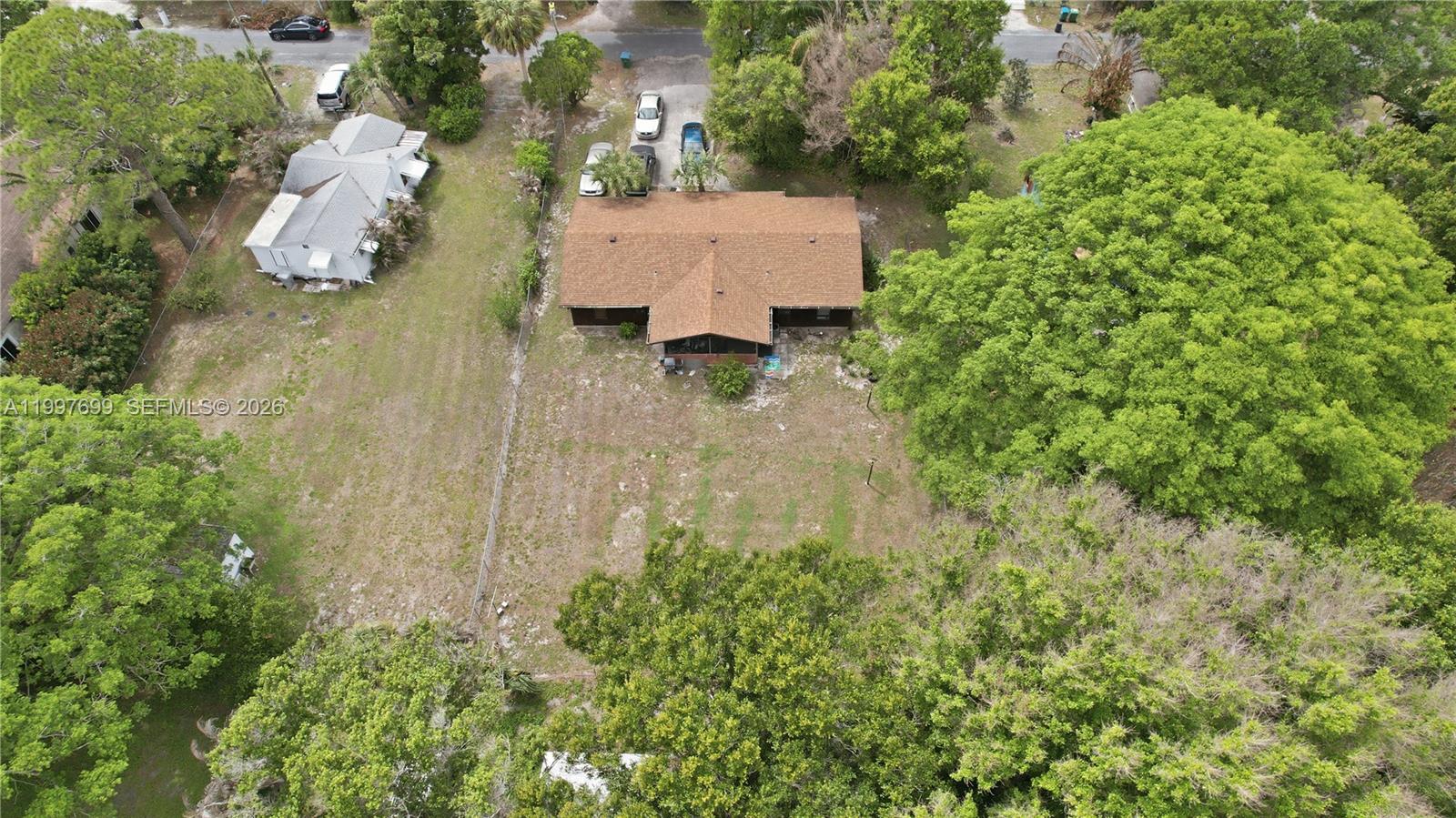 1910 South 34th Street Fort Pierce, FL 34947 - Photo 23 of 24 an aerial view of a house with a yard and trees