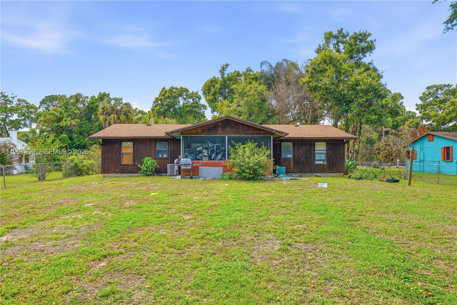 1910 South 34th Street Fort Pierce, FL 34947 - Photo 3 of 24 a front view of a house with a garden