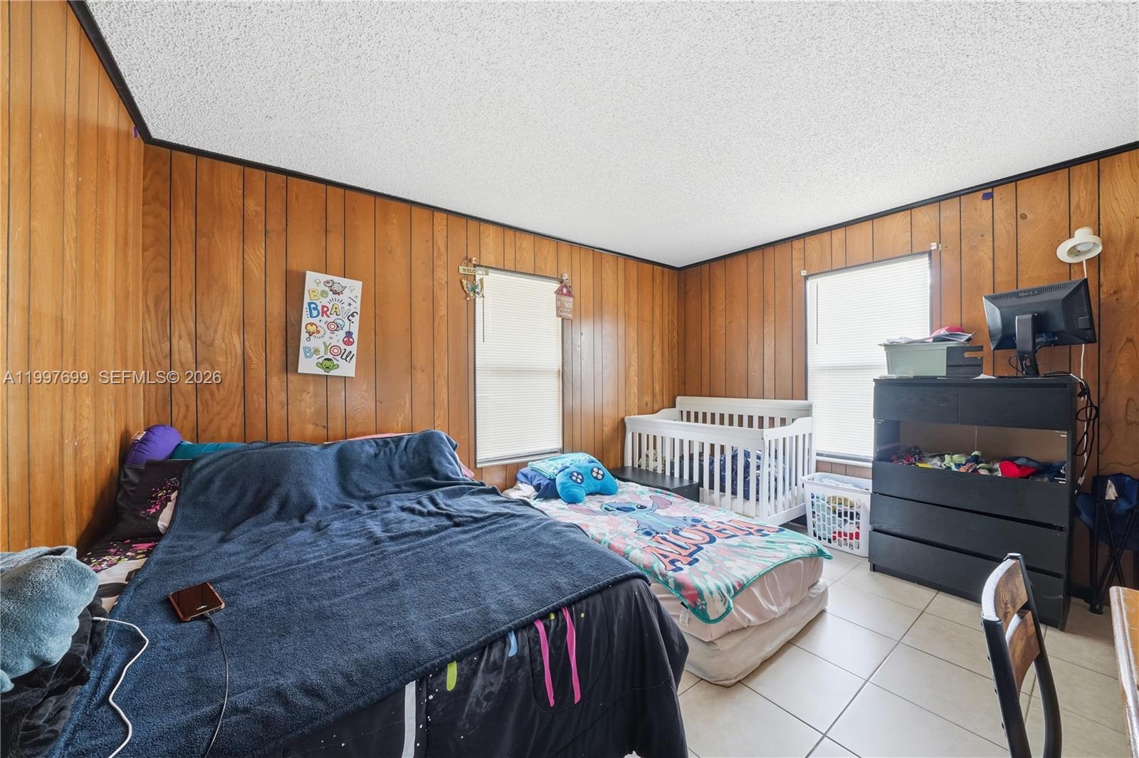 1910 South 34th Street Fort Pierce, FL 34947 - Photo 10 of 24 a bedroom with a bed and a television