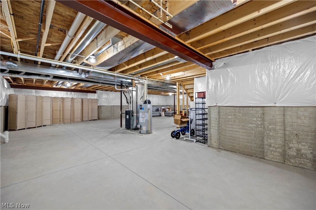 109 West Spring Drive Elyria, OH 44035 - Photo 40 of 46 Expansive unfinished basement featuring a concrete floor, exposed wood ceiling joists, and a steel support beam