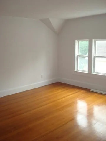 an empty room with a empty space and a window