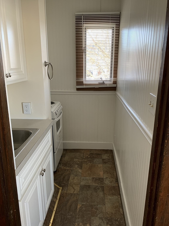 5-7 Abbott Street Wellesley, MA 02482 - Photo 18 of 28 a bathroom with a sink a toilet and a window