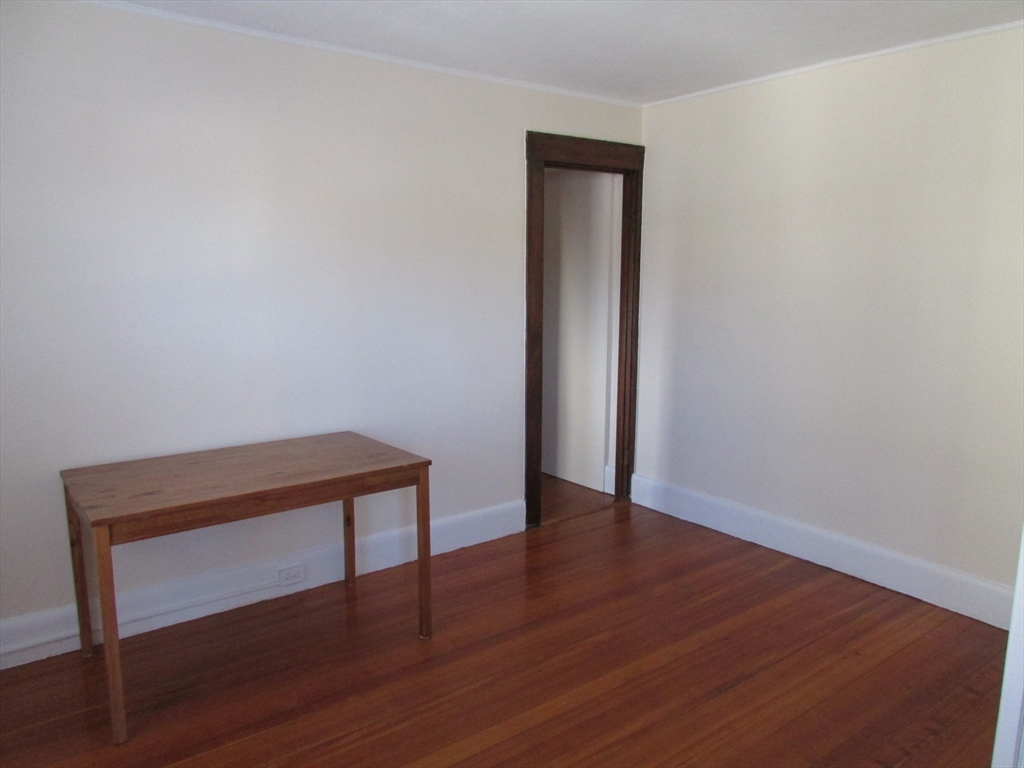 5-7 Abbott Street Wellesley, MA 02482 - Photo 19 of 28 a view of an empty room with wooden floor and a window