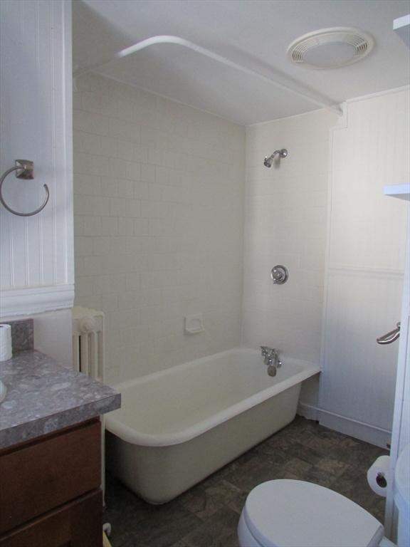5-7 Abbott Street Wellesley, MA 02482 - Photo 20 of 28 a bathroom with a granite countertop toilet a sink and bathtub