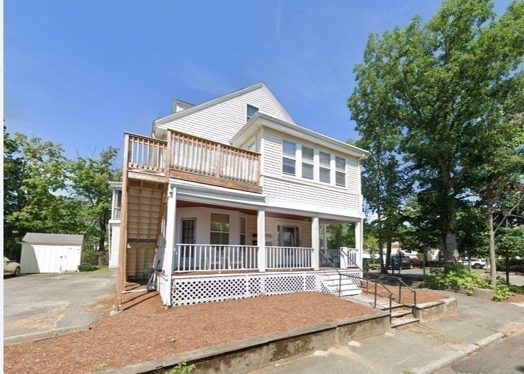 5-7 Abbott Street Wellesley, MA 02482 - Photo 3 of 28 a front view of a house with a garden