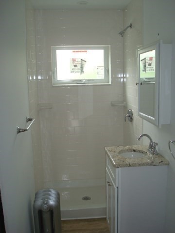 5-7 Abbott Street Wellesley, MA 02482 - Photo 10 of 28 a bathroom with a granite countertop sink a toilet and a mirror