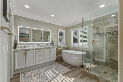 a spacious bathroom with a granite countertop sink and a mirror
