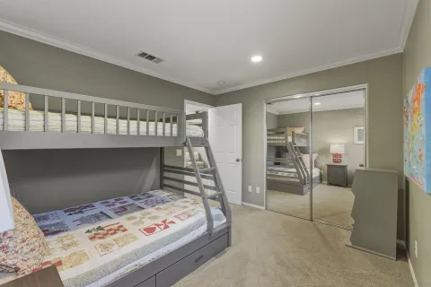 a bedroom with a bed and a dresser