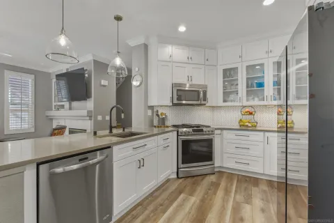 a kitchen with stainless steel appliances granite countertop a refrigerator sink and cabinets