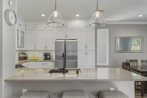 a kitchen with stainless steel appliances granite countertop a stove a sink and a microwave