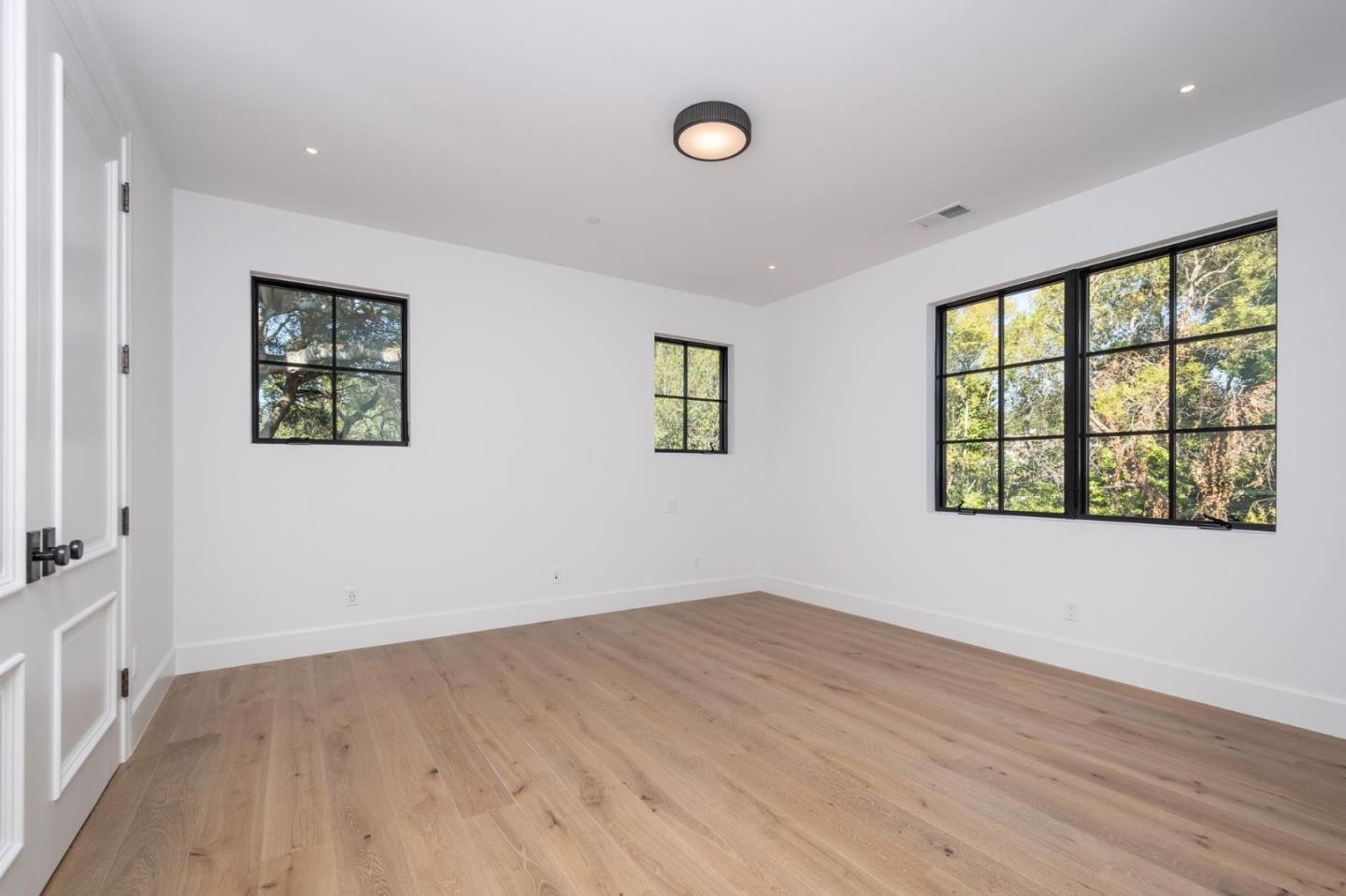 52 Middlefield Road Atherton, CA 94027 - Photo 30 of 45 an empty room with wooden floor and windows