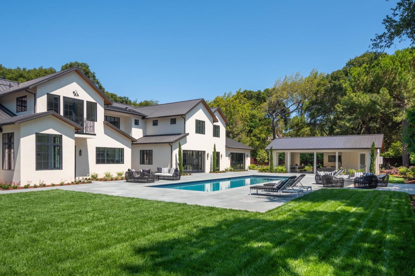 52 Middlefield Road Atherton, CA 94027 - Photo 39 of 45 a front view of a house with a yard table and chairs