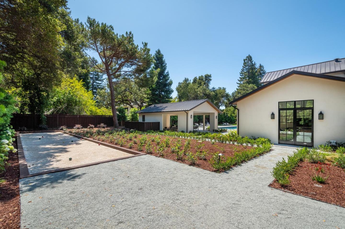 52 Middlefield Road Atherton, CA 94027 - Photo 41 of 45 a front view of a house with a yard and potted plants