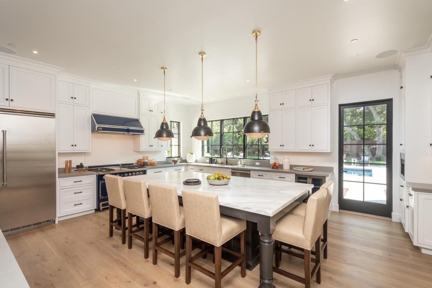 52 Middlefield Road Atherton, CA 94027 - Photo 9 of 45 a kitchen with stainless steel appliances a dining table chairs and wooden floor