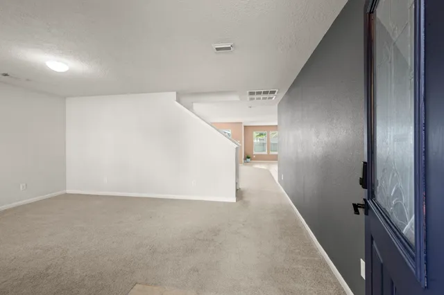 wooden floor in an empty room with stairs
