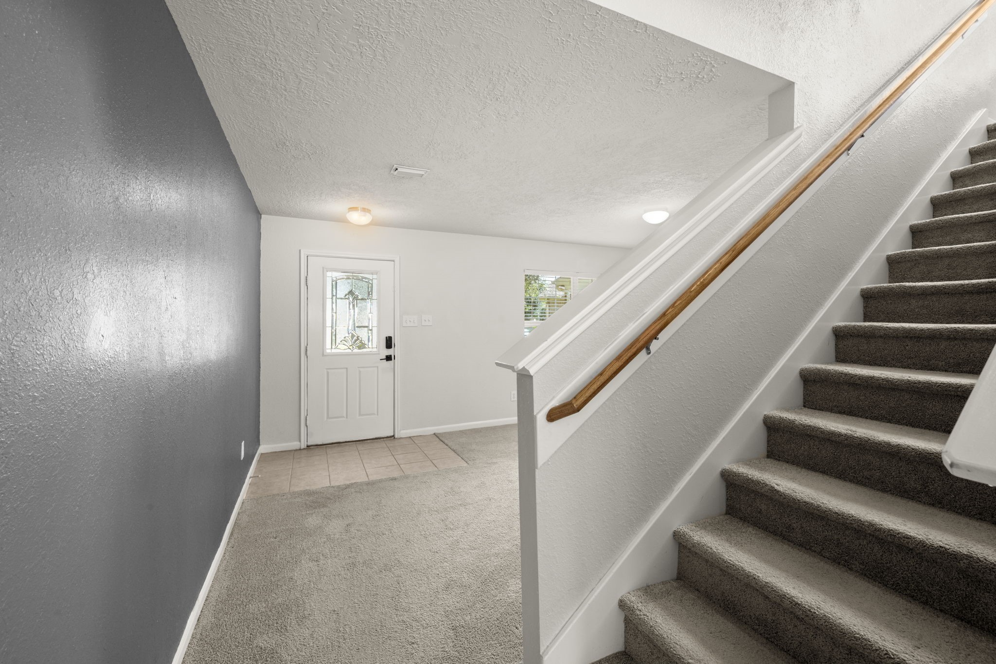 19819 Rippling Brook Lane Tomball, TX 77375 - Photo 14 of 29 wooden floor in an empty room with stairs