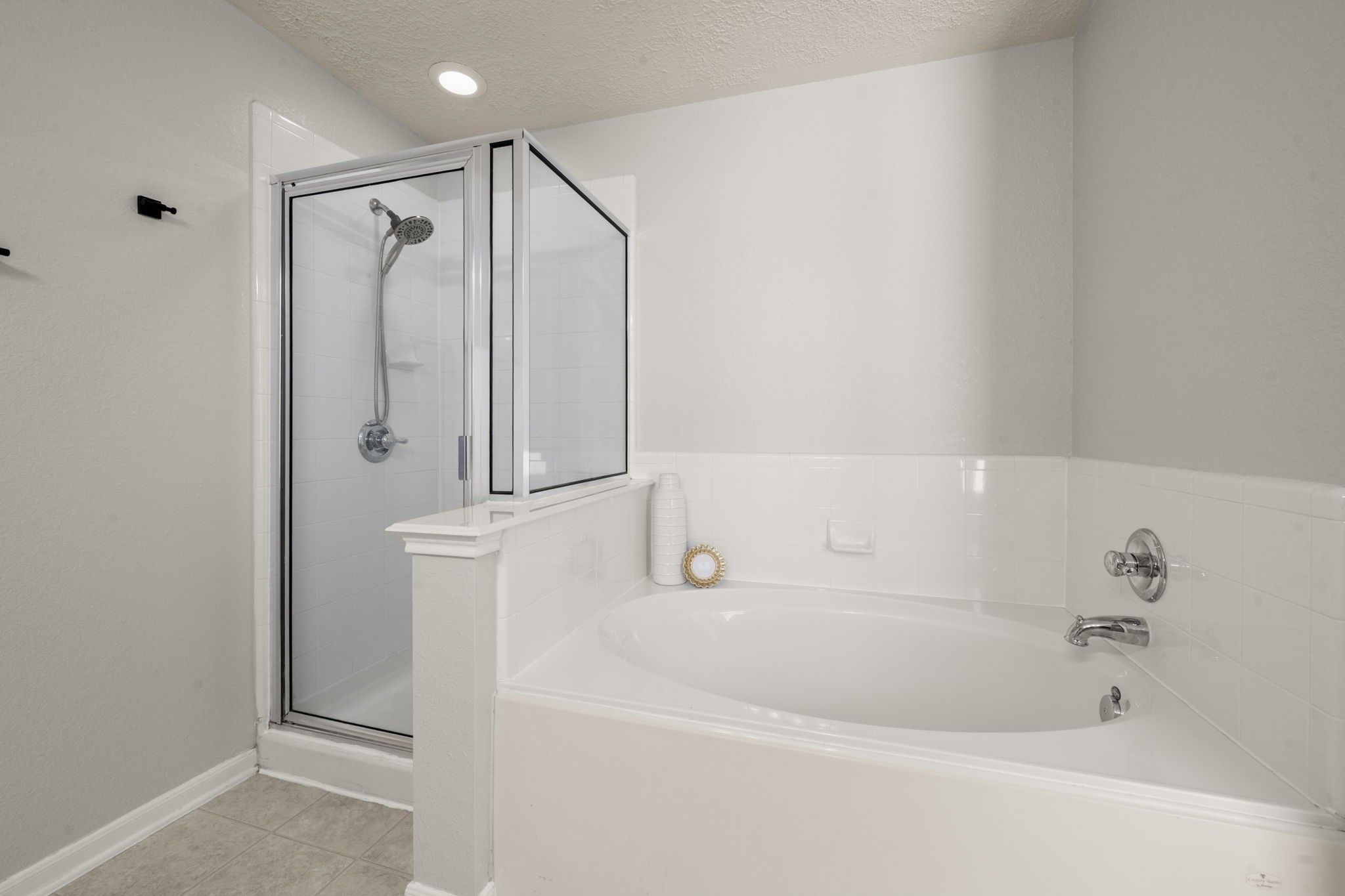 19819 Rippling Brook Lane Tomball, TX 77375 - Photo 20 of 29 a bathroom with a bathtub and a shower