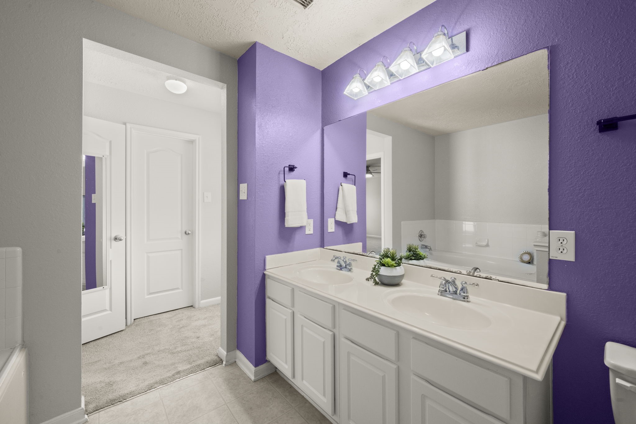 19819 Rippling Brook Lane Tomball, TX 77375 - Photo 21 of 29 a bathroom with a sink vanity tub and a mirror