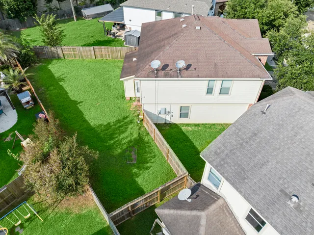 a view of an house with backyard space and balcony