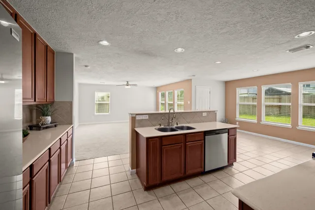 a kitchen with a stove sink and cabinets