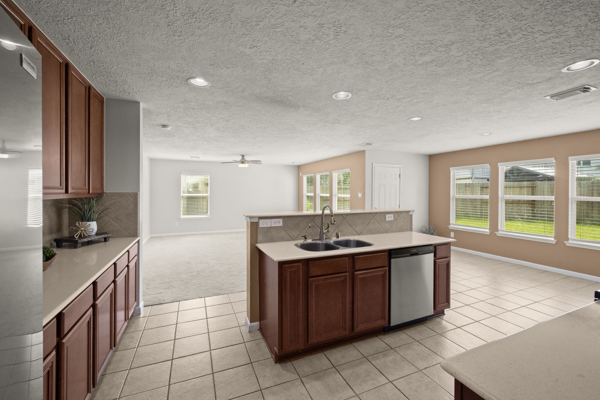 19819 Rippling Brook Lane Tomball, TX 77375 - Photo 4 of 29 a kitchen with a stove sink and cabinets