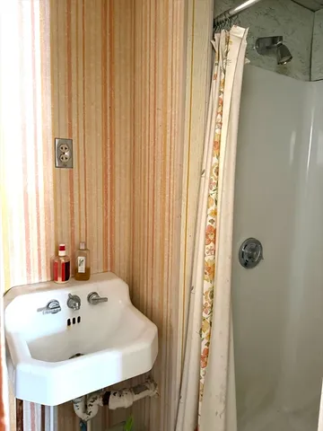 a white toilet sitting next to a bathroom sink