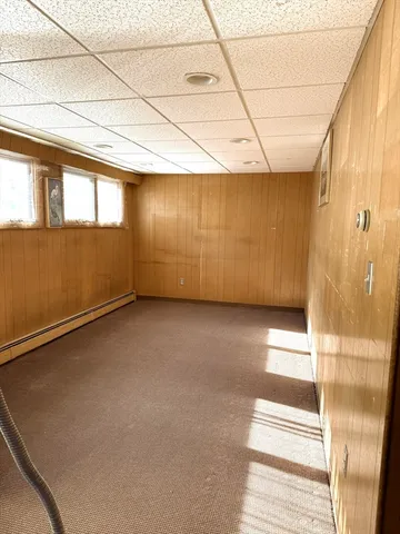 a bedroom with furniture and a large window