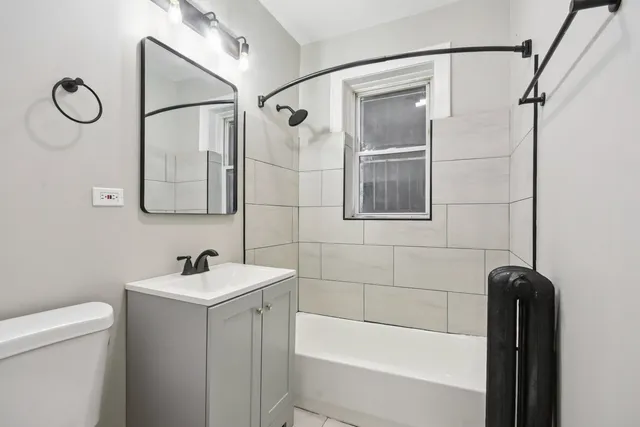 a bathroom with a shower a toilet and sink