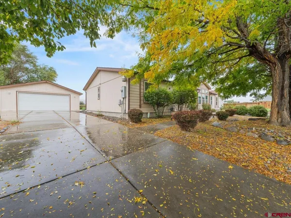 a view of a house with a yard and tree s