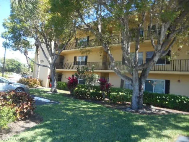 a front view of house with a garden
