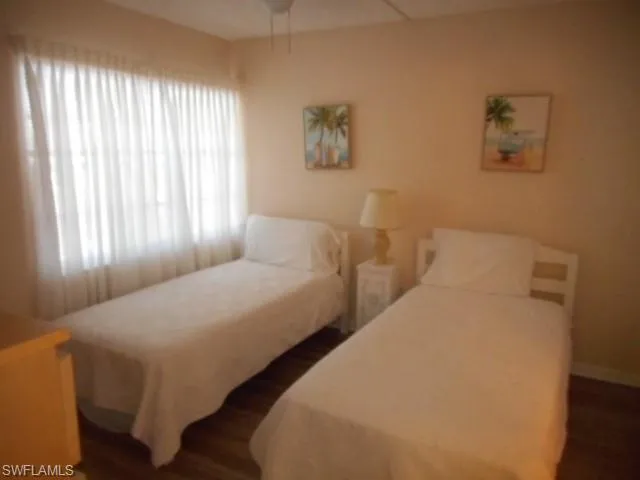 a bedroom with two beds and a window