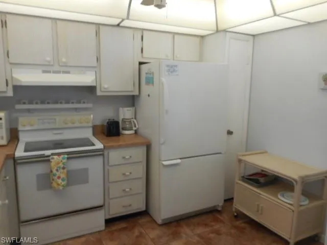 a kitchen with appliances and cabinets