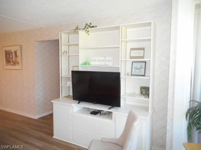 a living room with a flat screen tv and a fireplace