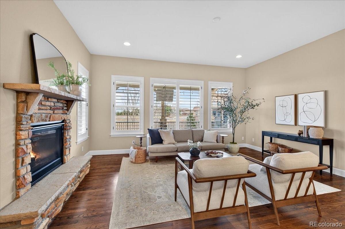 10693 Featherwalk Way Highlands Ranch, CO 80126 - Photo 18 of 50 a living room with fireplace furniture and a large window