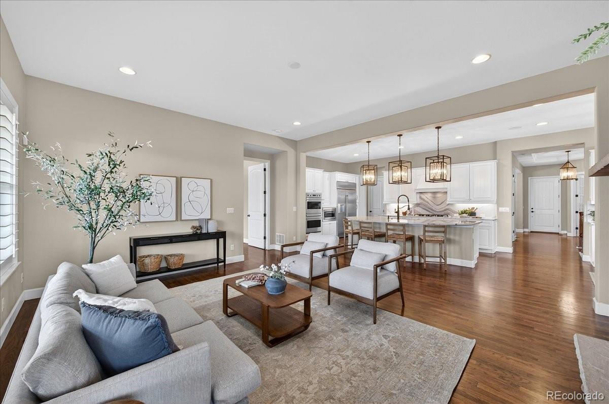 10693 Featherwalk Way Highlands Ranch, CO 80126 - Photo 21 of 50 a living room with furniture and wooden floor