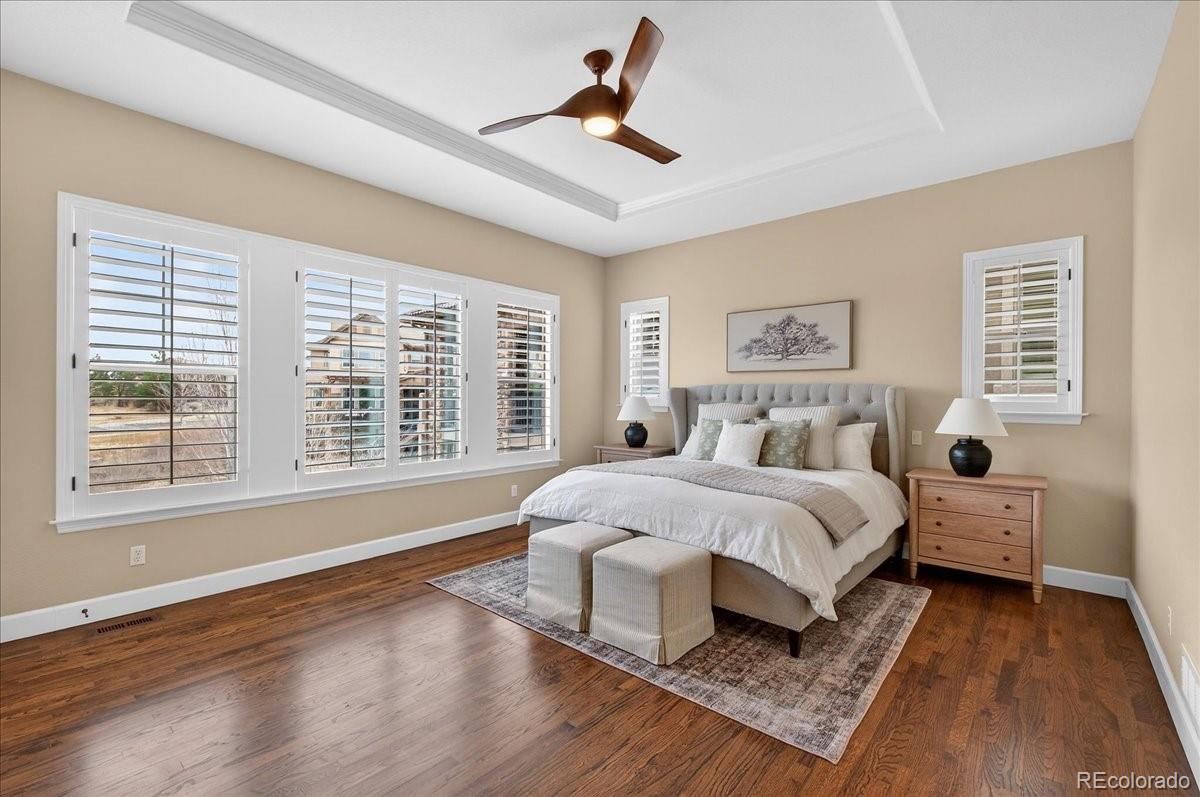 10693 Featherwalk Way Highlands Ranch, CO 80126 - Photo 22 of 50 a spacious bedroom with a bed and wooden floor