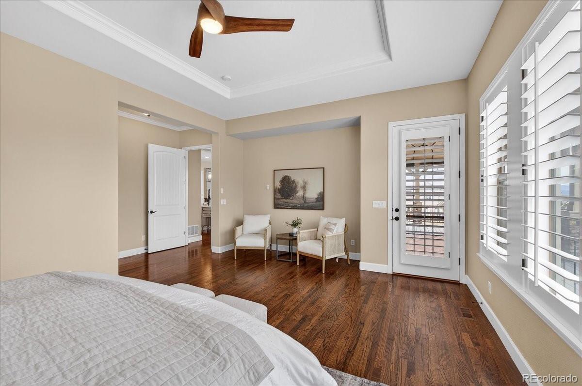 10693 Featherwalk Way Highlands Ranch, CO 80126 - Photo 24 of 50 a bedroom with furniture and wooden floor