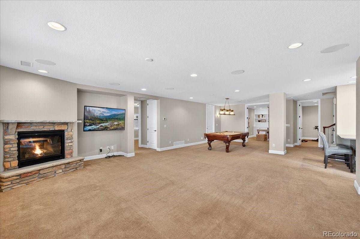 10693 Featherwalk Way Highlands Ranch, CO 80126 - Photo 32 of 50 a view of a livingroom with furniture and a fireplace