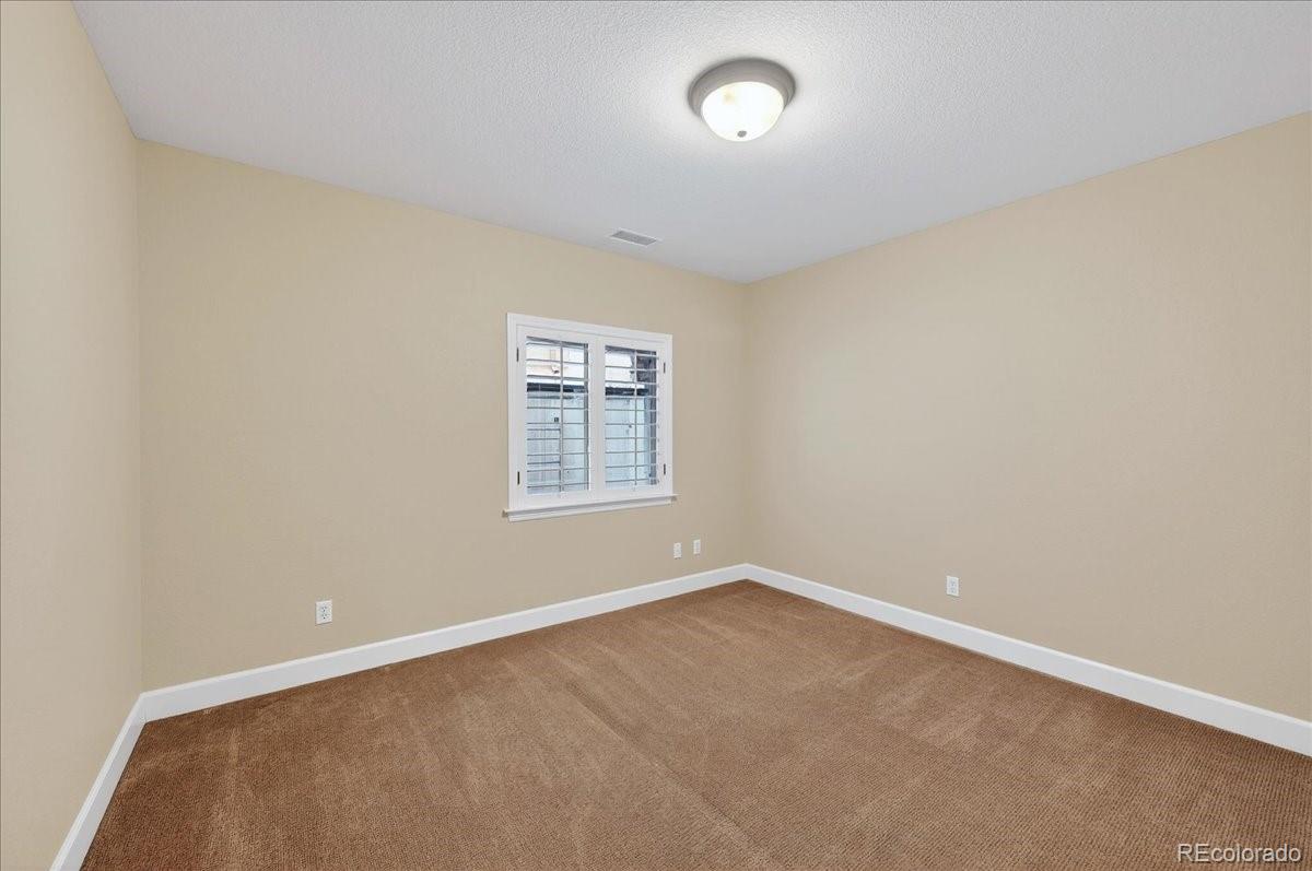 10693 Featherwalk Way Highlands Ranch, CO 80126 - Photo 37 of 50 an empty room with windows