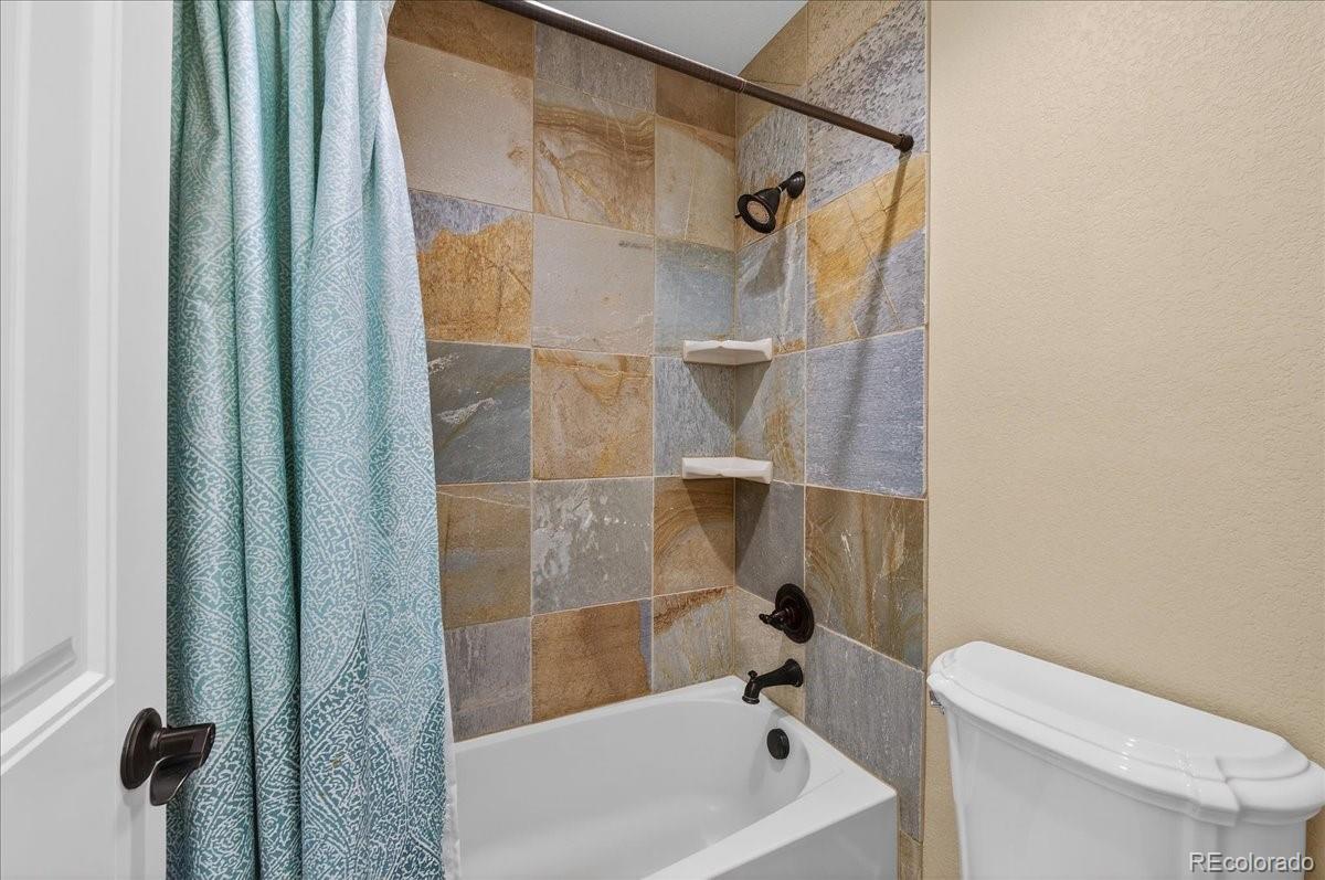 10693 Featherwalk Way Highlands Ranch, CO 80126 - Photo 39 of 50 a bathroom with a bathtub and a shower