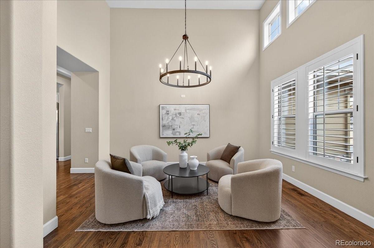 10693 Featherwalk Way Highlands Ranch, CO 80126 - Photo 7 of 50 a living room with furniture chandelier and a window