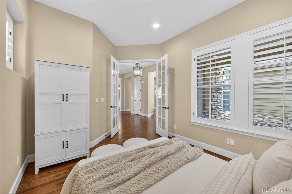 10693 Featherwalk Way Highlands Ranch, CO 80126 - Photo 9 of 50 a spacious bedroom with a bed and a window