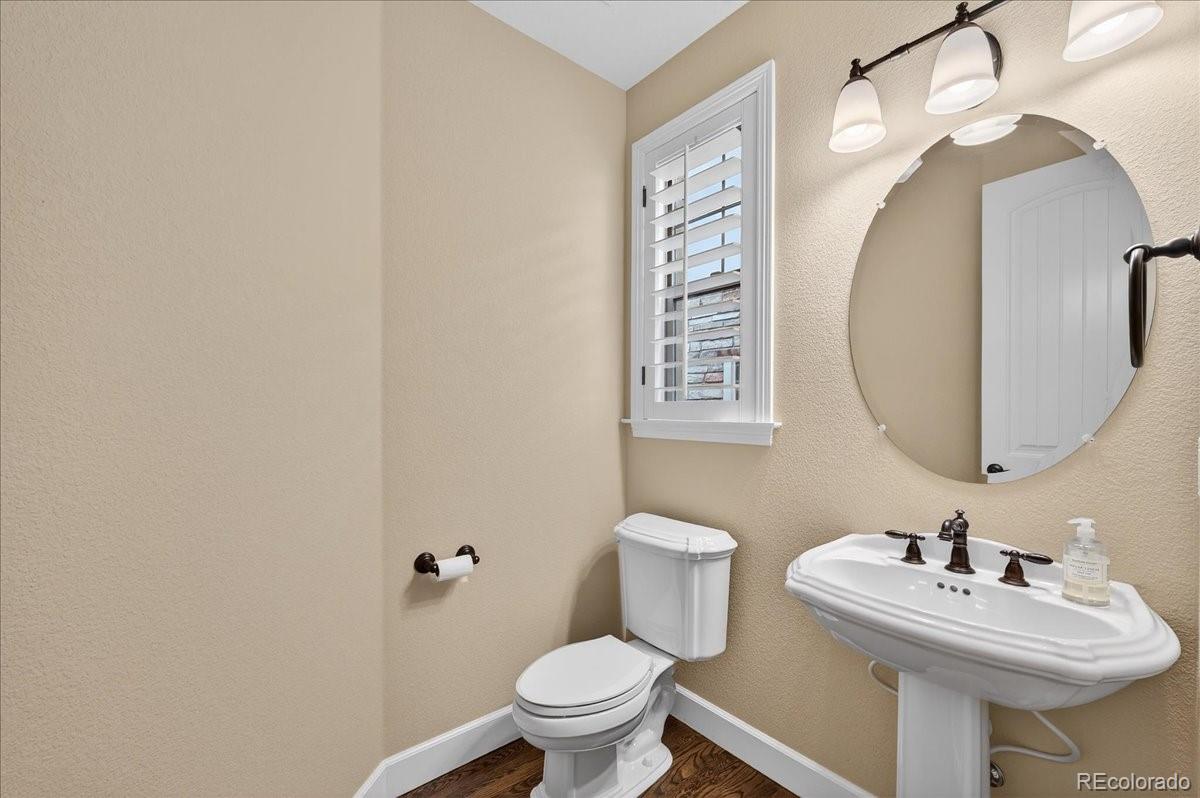 10693 Featherwalk Way Highlands Ranch, CO 80126 - Photo 10 of 50 a bathroom with a sink mirror and toilet