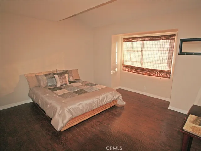 a bedroom with a bed and window