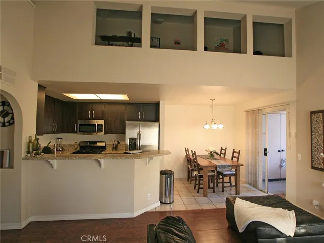 a kitchen with stainless steel appliances kitchen island granite countertop a sink and cabinets