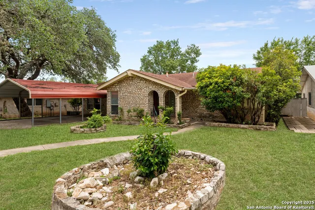 a front view of a house with a garden and porch