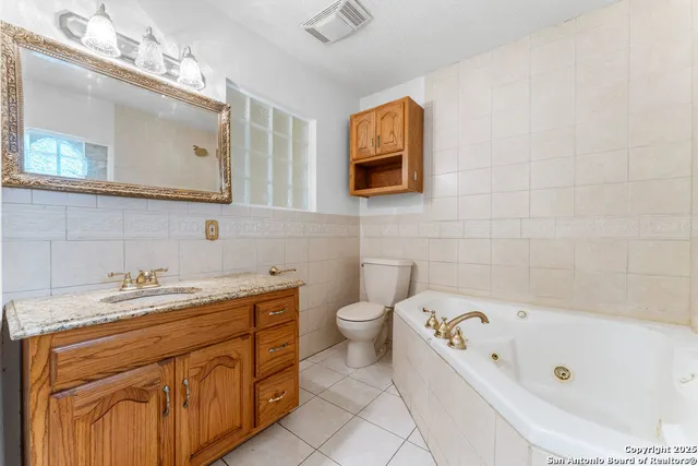 a bathroom with a tub sink and mirror