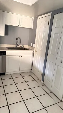 a view of a swimming pool with a patio and a yard